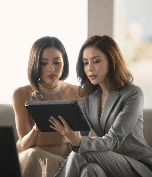 Two people reviewing a lighting brief on a tablet