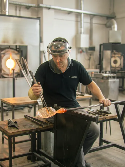 Master glassblower crafting a bespoke lighting component